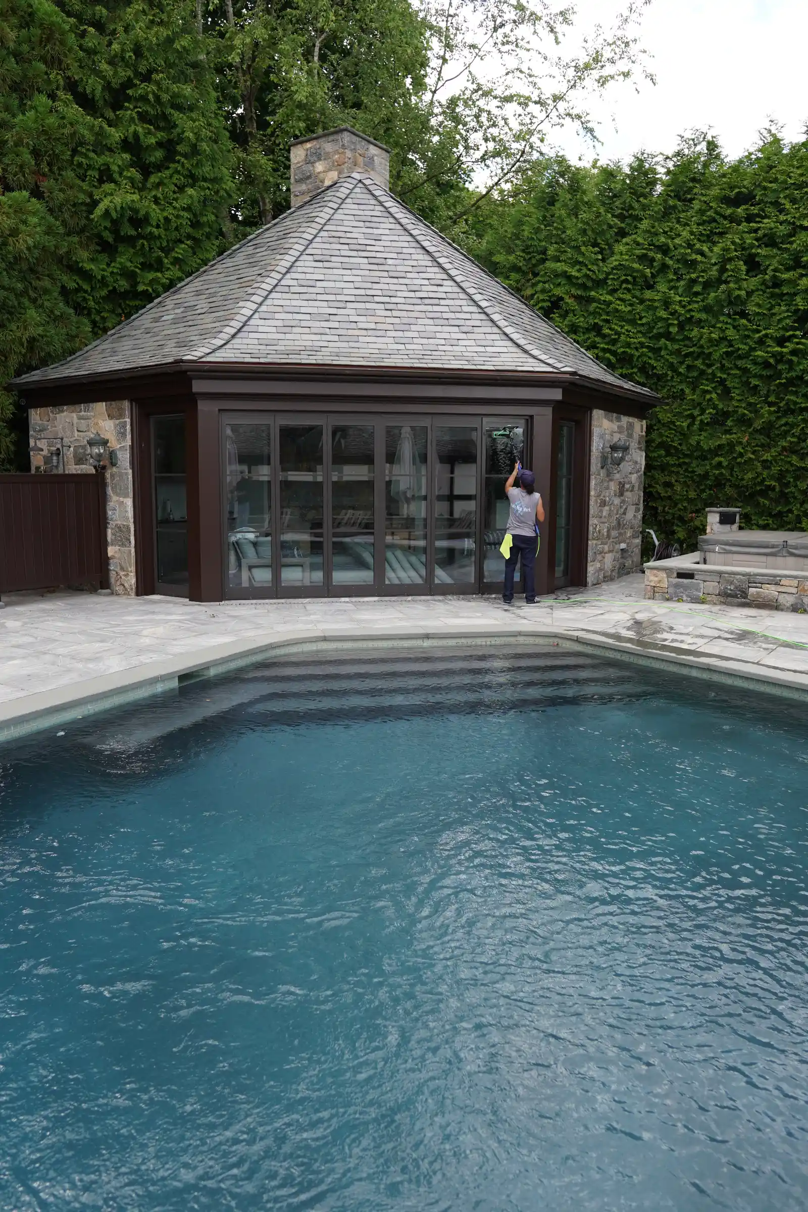 Pool house with freshly cleaned full-height glass beside the pool